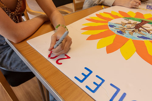 Chloe helping to make the Sunflower Logo Artwork